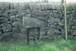 Click to enlarge image of possible re-used cross base in sheep hole of stone wall